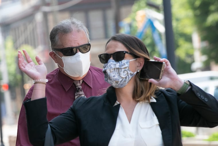 Ex-Bordentown Township Police Chief Frank Nucera enters the U.S. District Courthouse with his daughter, Christine, in Camden, on Wednesday.