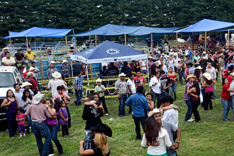 Thousands are drawn to a small field in Cumberland County for music and dance, food and bull-riding. "In Mexico, this is something we do instead of going to the mall." (TOM GRALISH / Staff Photographer)
