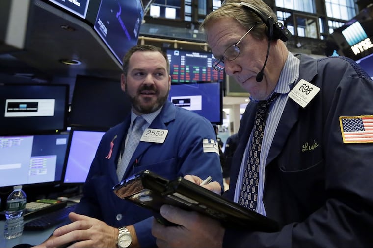 Specialist and trader on the “open outcry” floor of the New York Stock Exchange, 2017. Since the market’s biggest one-day crash 30 years ago, trading has accelerated to digital speeds, but markets remain fragile mechanisms that depend on cooperation between regulators and capitalists, Wall Street writer Diana Henriques argues in her book, A First-Class Catastrophe