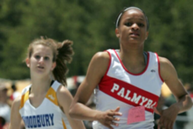 In the Group 1 girls' 200 meters, Palmyra's Rajeanna Marigna outpaces Woodbury's Andrea DiCarlo. Marigna also won the 100-meter high hurdles.