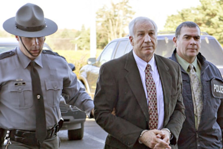 Former Penn State defensive coordinator Jerry Sandusky with police in November after being charged with sexually abusing eight boys. (Andy Colwell / The Patriot-News)