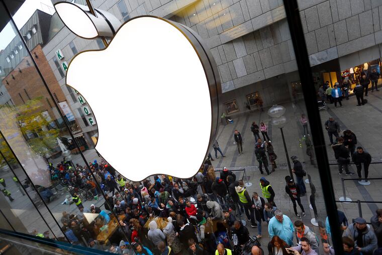 People wait in front of an Apple store in Munich, before the worldwide launch of the iPhone 6s.