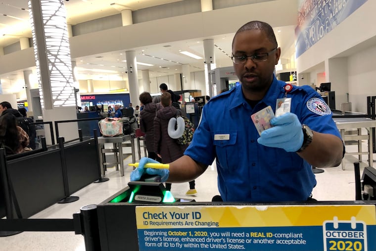 A TSA security officer checks passengers' IDs at Baltimore/Washington International Thurgood Marshall Airport in 2019.
