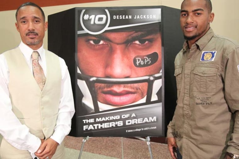 DeSean Jackson (right) and his brother Bryon pose by the poster before the screening of a movie about DeSean and his father, Bill. (Charles Fox/Staff Photographer)