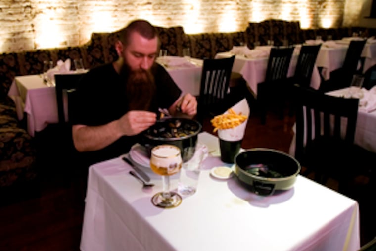 Zot is the new restaurant just off Head House Square. Sous chef Joseph Monczewski samples a house specialty: steamed mussels and french fries.
