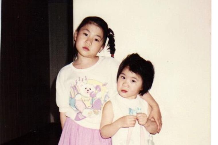 Becky Cheung, right, with her sister Karen Cheung-Larivee in Wissinoming in 1989.
