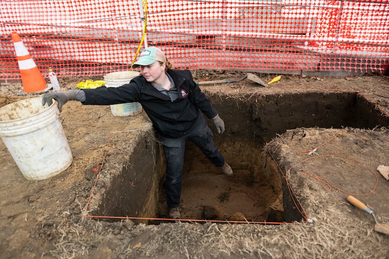 Chelsea Carriere, archeologist with PS&S, grabs for a bucket while digging at Croft Farm in Cherry Hill, N.J., on Saturday, Feb. 21, 2026. Croft Farm, listed on the National Register of Historic Places, is now an active archaeological site due to the farm's role during the time of the Underground Railroad.
