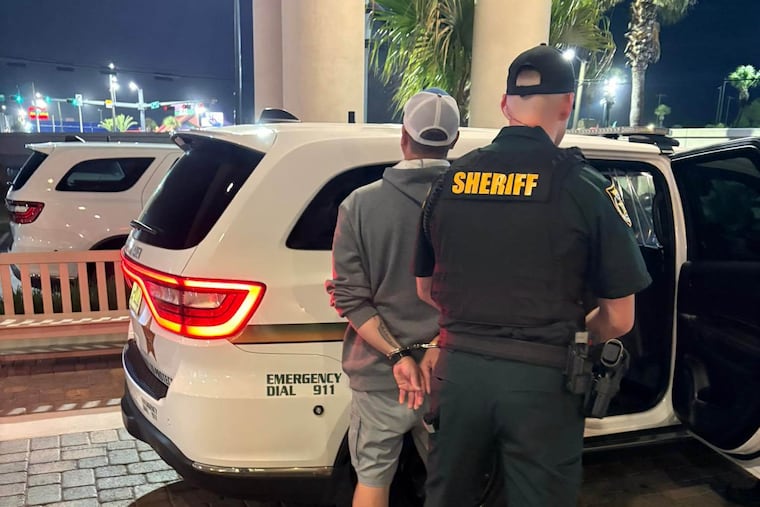 This photo provided by the Okaloosa County Sheriff's Office shows Christopher Gillum being arrested Wednesday at a hotel in Destin, Fla.