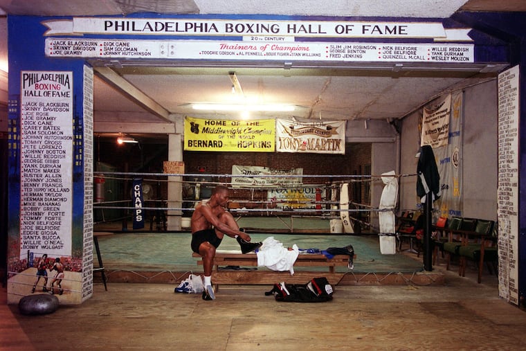 Bernard Hopkins ties his shoes at Champs Gym before a workout. he has trained at the North Phila. gym with trainer Bouie Fisher throughout his career.