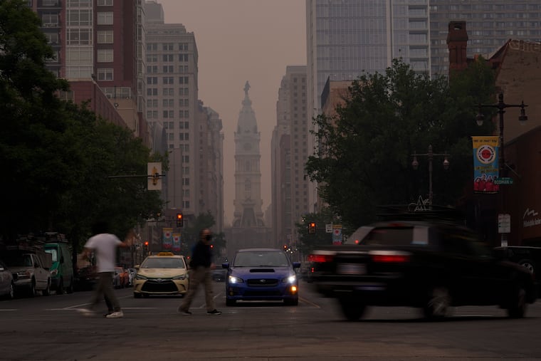 Evening commuters travel on Broad Street past a hazy City Hall, Wednesday, June 7, 2023, in Philadelphia. Smoke from Canadian wildfires poured into the U.S. East Coast on Wednesday.