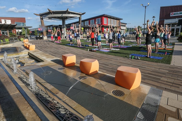 The last Yoga class of the summer in the open space at the King of Prussia Town Center.