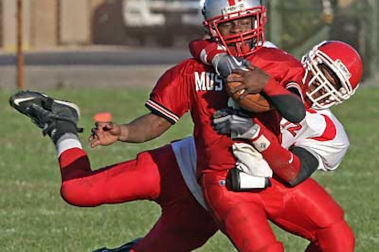 Dobbins' James Karon has a short gain as Gratz's William Wood brings him down during the 4th quarter. ( Steven M. Falk / Staff Photographer )