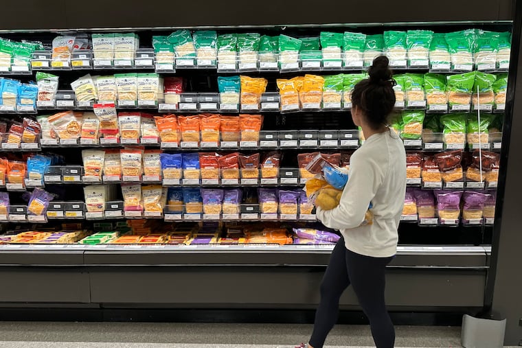 A shopper peruses the refrigerated offerings in a Target store in Sheridan, Colo.