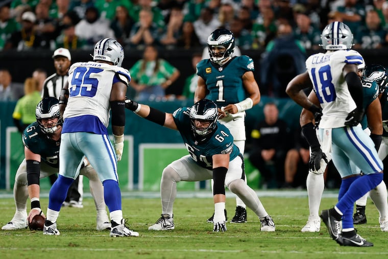 Eagles offensive guard Brett Toth calls line signals as Jalen Hurts looks over the Dallas defense.