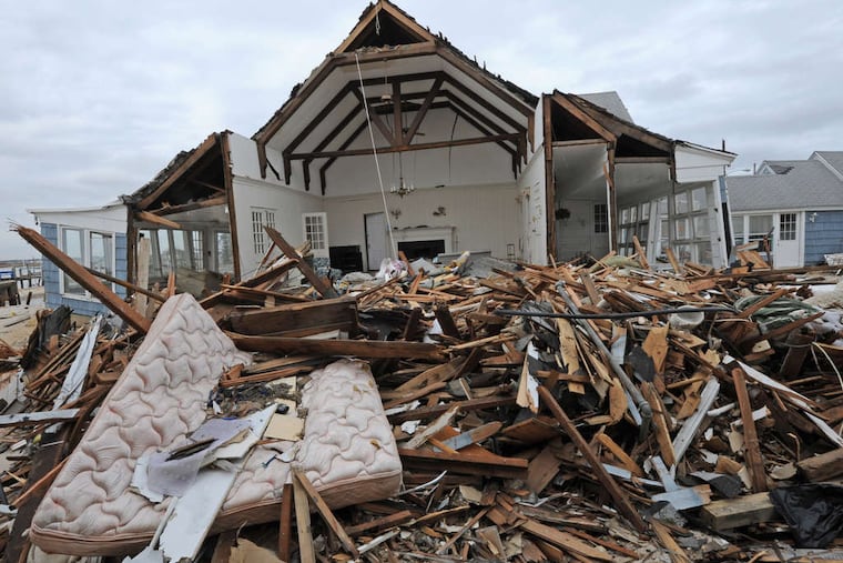 The wreckage of a house opened wide by Sandy sits on the bay in Mantoloking.