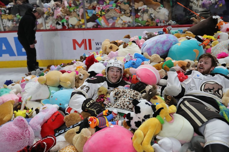 Hershey forward Grant Cruikshank in a pile of teddy bears during the Bears' Jan. 5 Teddy Bear Toss game.