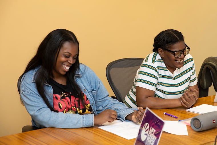 Parents Siani Bolling (left) and Keisha Nicholson speak during a meeting with Lift Every Voice, a grassroots group of Philadelphia parents. Lift Every Voice is mounting a campaign for a "chief joy officer" in Philly schools.