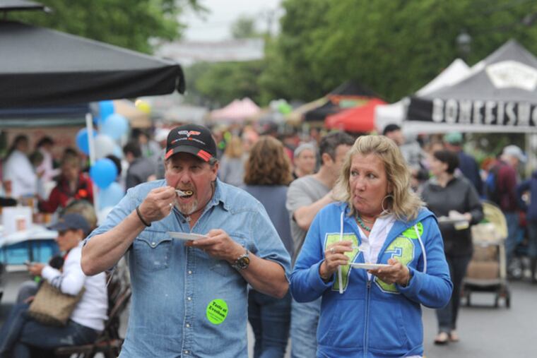 Mike and Donna Hesse of Mount Laurel stroll down Main Street in Evesham during the fifth annual "Taste of Evesham" day. (Clem Murray / Staff Photographer)