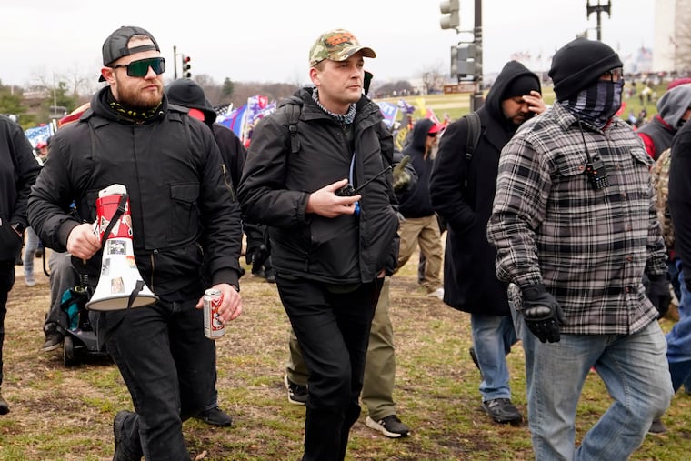 In this Jan. 6, 2021, photo, Proud Boys members Ethan Nordean (from left), Zachary Rehl, and Joseph Biggs walk toward the U.S. Capitol in Washington.