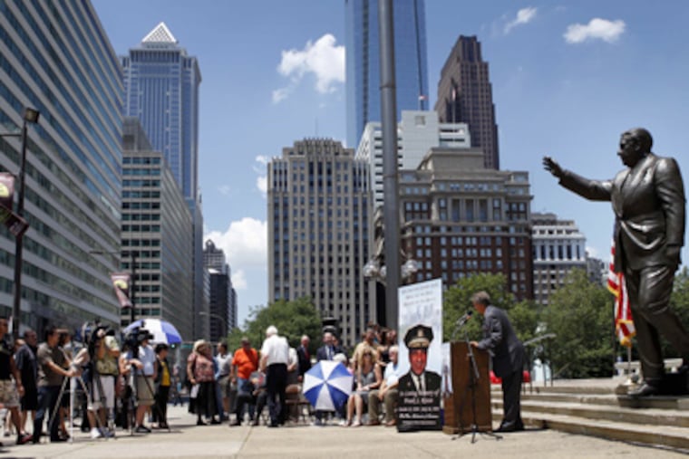 Friends and family of former Philadelphia Mayor Frank Rizzo gather at his statue in front of the Municipal Services Building for the 20th annual memorial service for the former mayor on Saturday afternoon. (Laurence Kesterson / Staff Photographer)