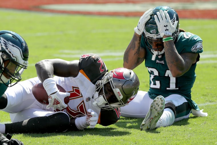 Ronald Darby (right) reacts after the Bucs' Chris Godwin catches a pass for a first down in front of him on Sunday.