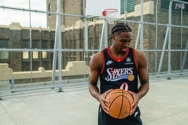 Tyrese Maxey poses in the Sixers' Allen Iverson era black jerseys that they're bringing back to celebrate the 25th anniversary of the franchise's NBA Finals appearance.