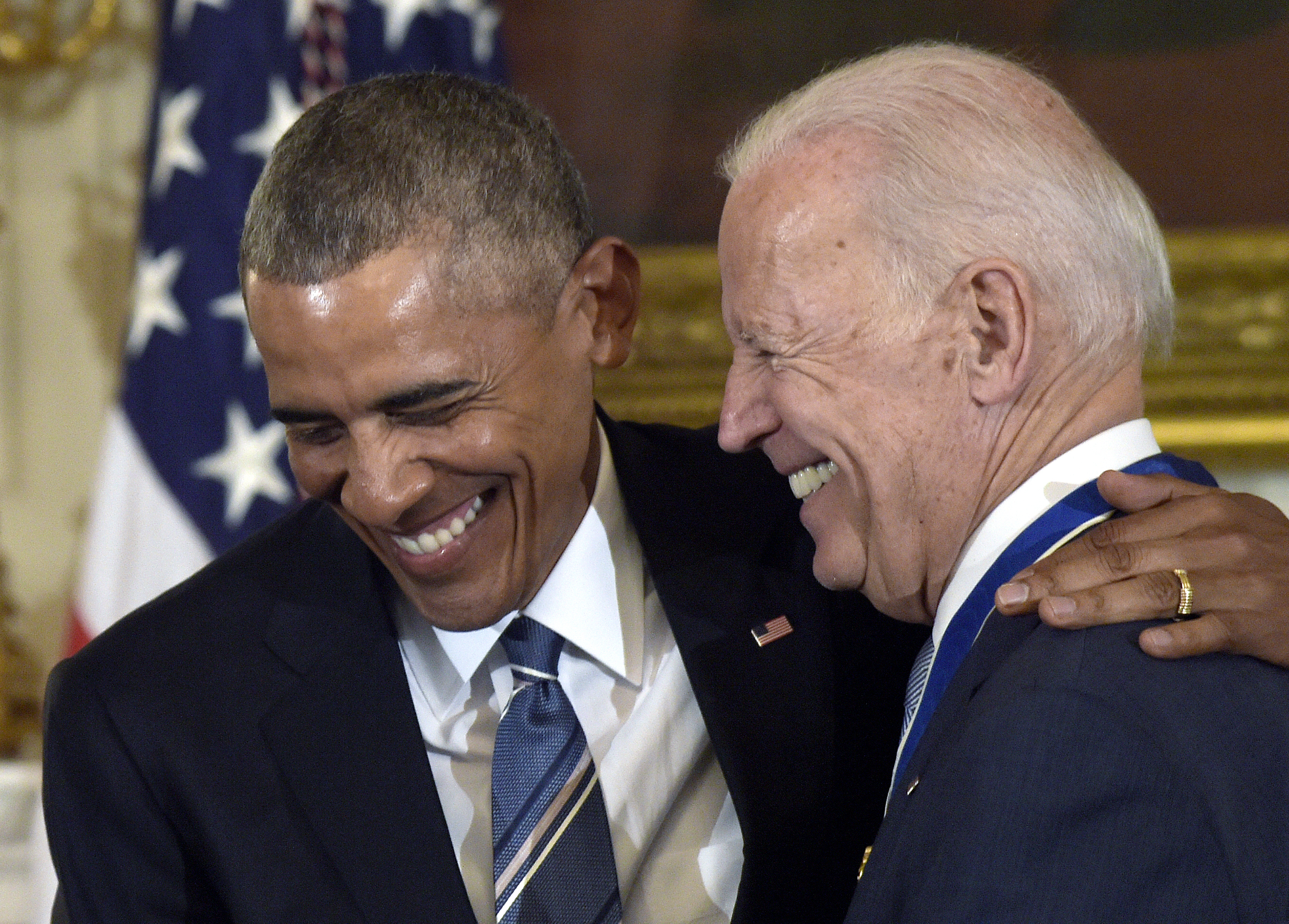 President Barack Obama laughs with Vice President Joe Biden during a 2017 ceremony in the State Dining Room of the White House, where Obama presented Biden with the Presidential Medal of Freedom.