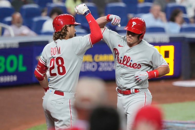 Alec Bohm congratulates J.T. Realmuto after Realmuto's sixth-inning solo homer.