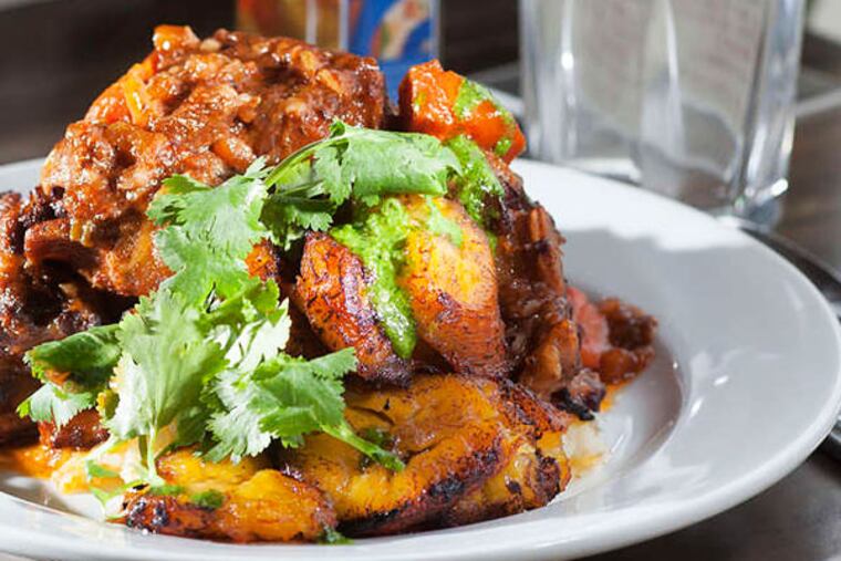 The oxtail stew is a soulful plate of pure Latin comfort. The oxtails are simmered in soffritto and malbec until the tender meat slips off the bone into silky malanga-potato mash. (ED HILLE / Staff Photographer)