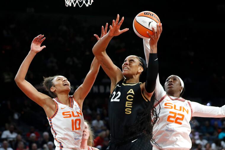 Las Vegas Aces forward A'ja Wilson shoots between Connecticut's Olivia Nelson-Ododa (10) and Liz Dixon on July 1.