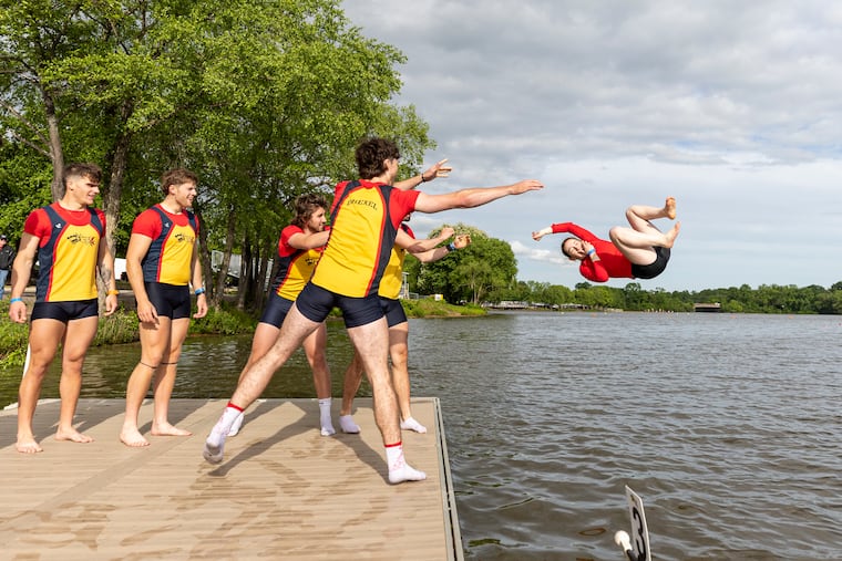 Drexel's men's rowing team tosses its coxswain, Chloe Minicucci, into the Cooper River after winning the men's varsity eight grand final on Day 2 of the Dad Vail Regatta on Saturday.