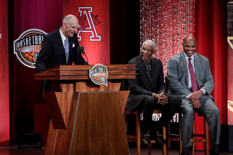 Inductee Bobby Jones speaks as his presenters, Julius Erving (middle), and Charles Barkley, laugh during the Basketball Hall of Fame enshrinement ceremony Friday, Sept. 6, 2019, in Springfield, Mass.