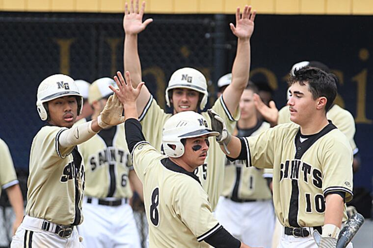 Neumann-Goretti's Joe Lolio is congratulated by teammates Bay To and Nicky D'Amore after scoring in the fourth inning. (Charles Fox/Staff Photographer)