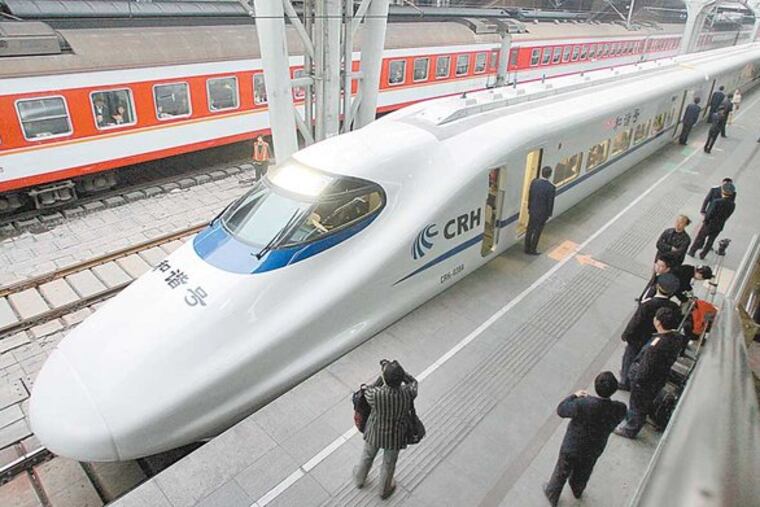 Train attendants take their positions, as they wait for passengers to board a bullet train heading for Tianjing, at the train station in Beijing Wednesday, April 18, 2007.
