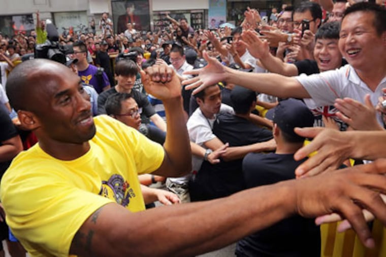 Kobe Bryant shakes hands with Chinese fans during an event in Wuhan in central China. (AP Photo)