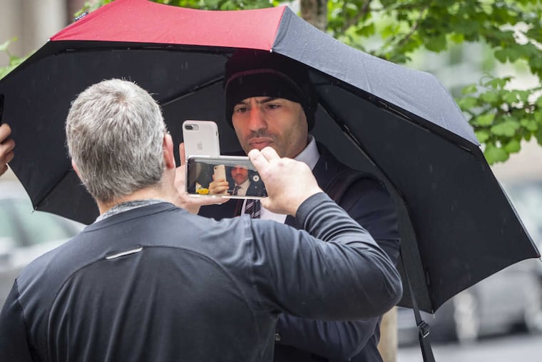 Lawyer Aaron Schlossberg (center), the man who ranted against the people speaking Spanish in a Midtown restaurant, takes a cellphone video of reporters recording him on video as he leaves his home in Manhattan on Thursday, May 17, 2018.