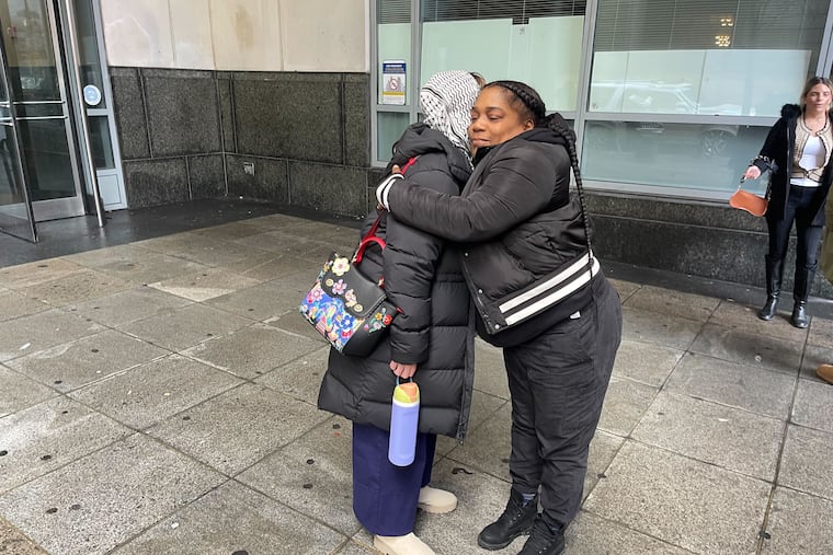 Theresa Guyton, right, hugs Meredith Elizalde outside the Philadelphia criminal courthouse on Thursday, Feb. 13. Their sons were both killed by the same young men.