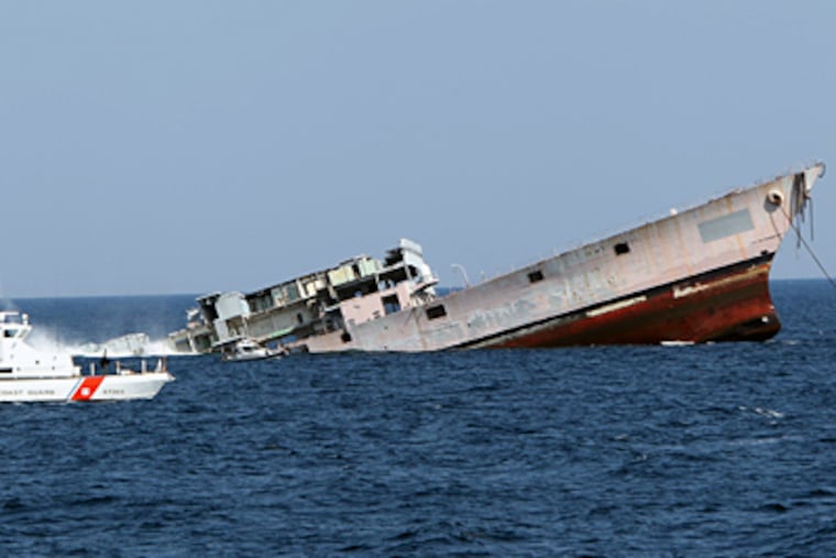 The bow of the USS Arthur W. Radford rises as the Navy destroyer slips into the sea to be used as an artificial reef off Cape May Point. That was Aug. 10; a few weeks later, Irene's surge slammed it. (David M Warren / Staff Photographer)