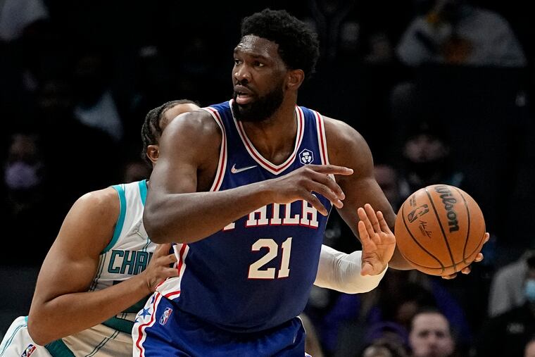 Charlotte Hornets forward P.J. Washington knocks the ball away from Philadelphia 76ers center Joel Embiid during the first half Monday night in Charlotte. Embiid finished with 43 points, 15 rebounds and seven assists in the Sixers' 127-124 win in overtime.