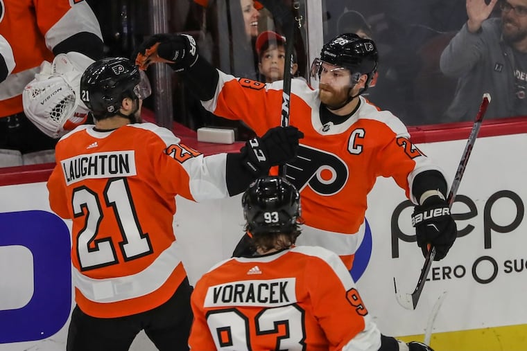 Claude Giroux (right), with Scott Laughton and Jake Voracek after his game-winning goal vs. Boston last week.