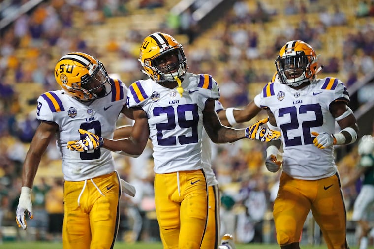 LSU cornerback Greedy Williams (29) celebrating his interception with safety Grant Delpit (9) and cornerback Kristian Fulton (22) in the second half of a September game against Southeastern Louisiana.