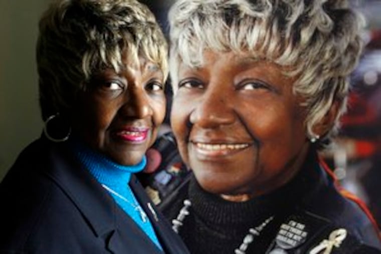 Emma Fulton, cancer-free for three years, with a poster with her picture that illustrates Delaware's cancer program. At 66 she's now on Medicare, but is glad help was there.