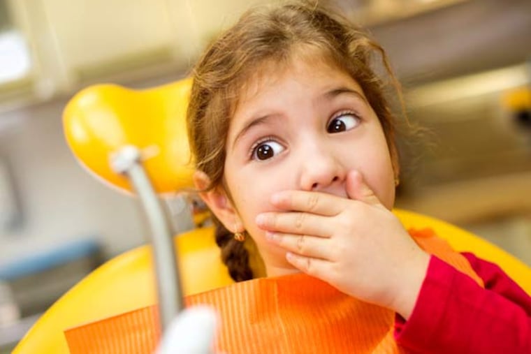 Young girl at the dentist.
