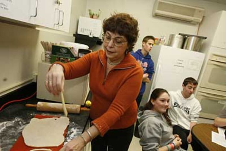 Aliza Green teaches a class of Jewish teenagers to make teiglach, a dessert taken by Jewish traders from Italy to Eastern Europe. The name, in Yiddish, means "little bits of dough." (CHARLES FOX / Staff Photographer)