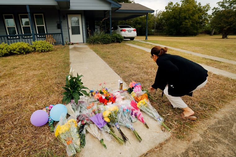 Anastasia Gonzalez of Burleson, Texas leaves a flowers on the front sidewalk of Atatiana Jefferson's home on E. Allen Ave on Oct. 15, 2019 in Fort Worth. In the wake of Fort Worth officer Aaron Dean shooting and killing Jefferson in her home, people have been leaving flowers at a memorial.