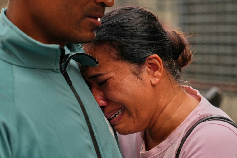 A relative consoles Sabina Dangal outside a government hospital as she waits for news of her brother, who is missing after flash floods, in Kathmandu, Nepal, Friday, Aug. 28, 2026.