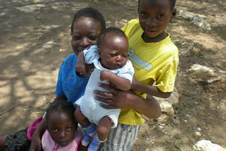 Thanks to Tariro, Ashleen Chipirare, 7, holding brother Edward, is in school. But she and her mother, Edna, and sister Florence still beg for a living in Harare, Zimbabwe. (Trishula Patel)