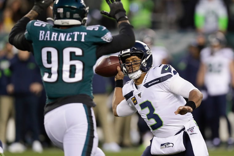 Seattle Seahawks quarterback Russell Wilson throws the football past Eagles defensive end Derek Barnett during the first-quarter in a NFC Wild Card playoff game in January.