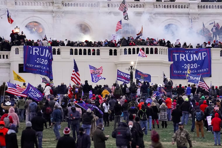Rioters supporting President Donald Trump storm the Capitol in Washington, Jan. 6, 2021. The Justice Department requested charges be dismissed against four top members of the Proud Boys charged with seditious conspiracy in relation to the riot.