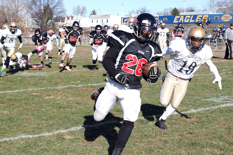Archbishop Ryan High's Samir Bullock runs past George Washington High's Terry Hall during the first quarter on his way to a touchdown.